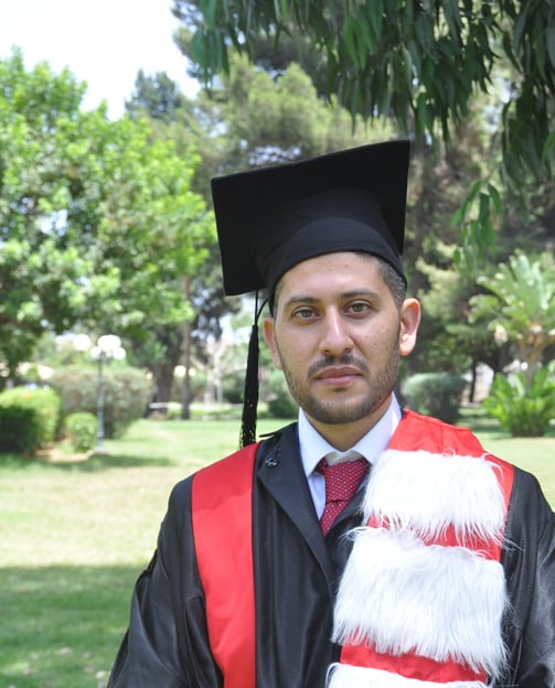 a man in a graduation gown and a cat in a graduation cap