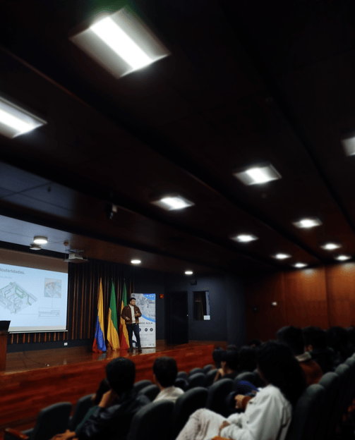 an important man standing in front of a presentation on an architectural presentation