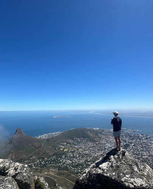 The top of Table Mountain with a view of Lions Head, Robben Island and Cape Town