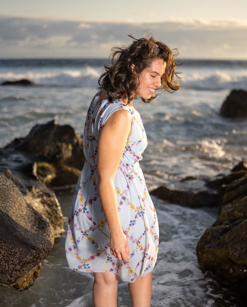 a woman in a dress standing in the water