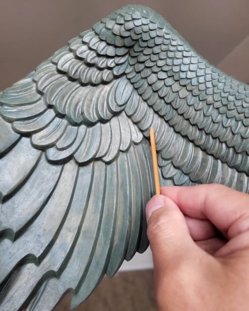 Creating the Garuda wings of clay.