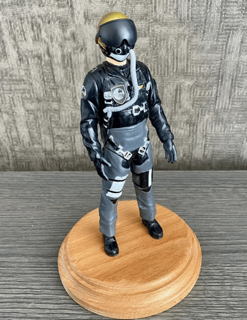 a toy figure of a man in a pilot suit