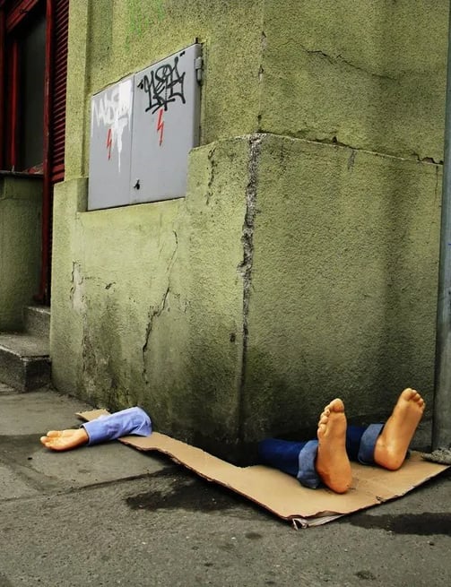 Em Praga, Fra.Biancoshock criou uma intervenção impactante que retrata um morador de rua sendo esmag
