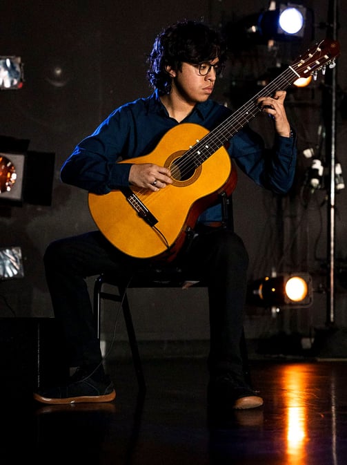 Chris Galindo playing a classical guitar