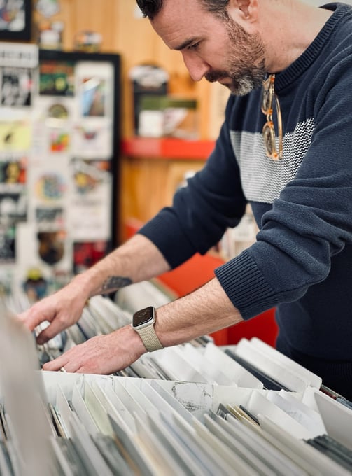 A man looking through vinyl records in a shop
