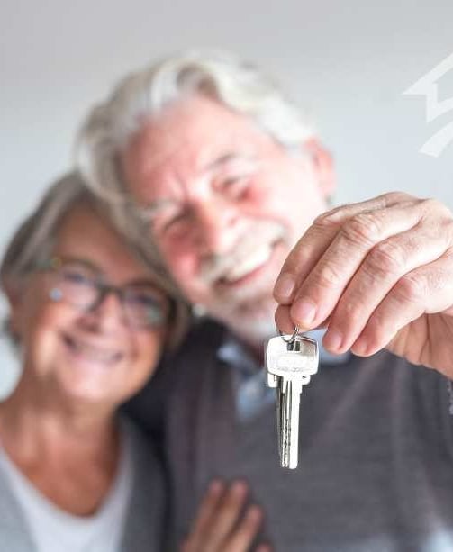happy older couple keys in hand