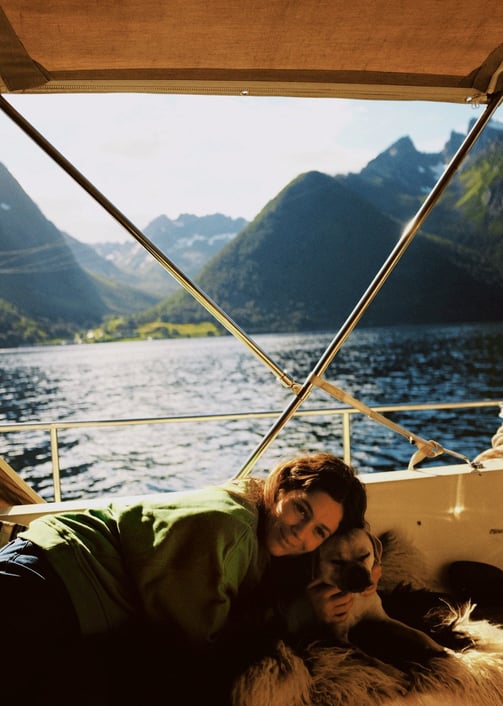 elaxing moment at sea—guest and dog enjoying a peaceful break on board in the Norwegian fjords.