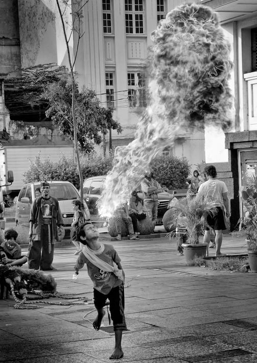 A young Indonesian street performer in Jakarta by photographer, Peter Pickering