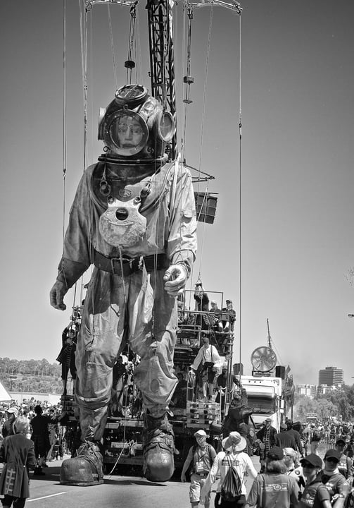 Peter Pickering photographs a giant man in a diving suit in Perth.