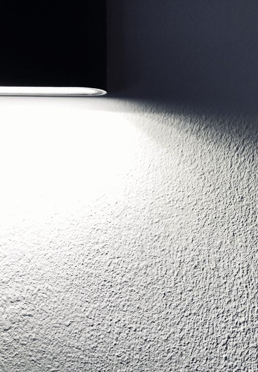 Textured home interior wall lit by spotlight, suitable for illustrating hidden damages assessed during insurance claims.