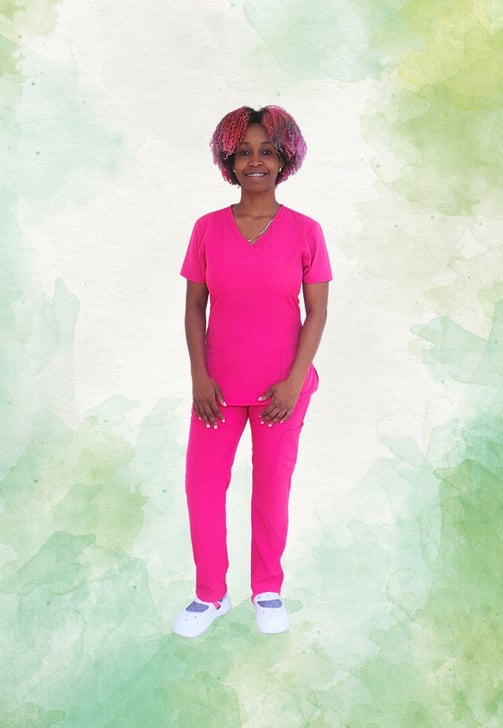 a woman in a pink scrub suit standing in front of a green background