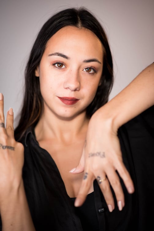 a woman with tattoos on her hands and a tattoo on her hand