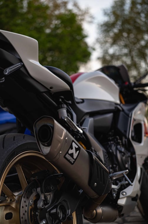 a motorcycle parked next to a parked car