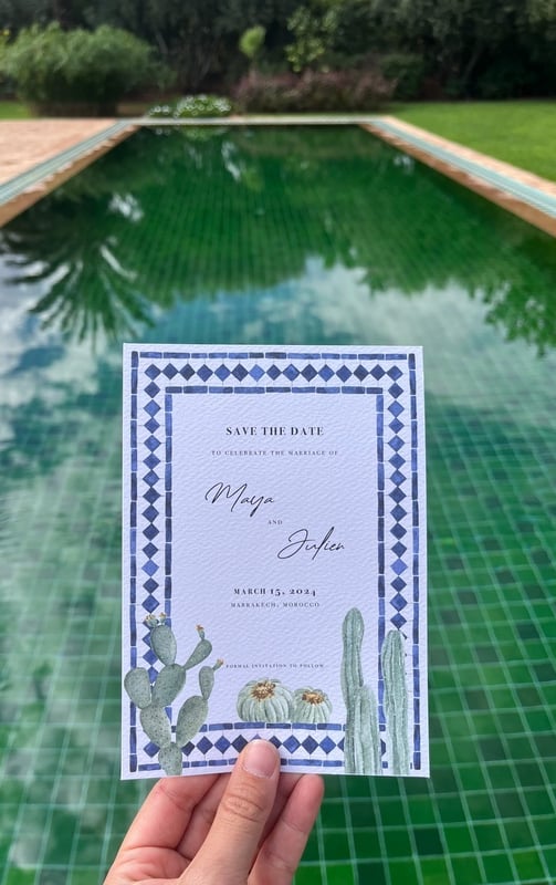 moroccan wedding invitation with a tile green pool in the background