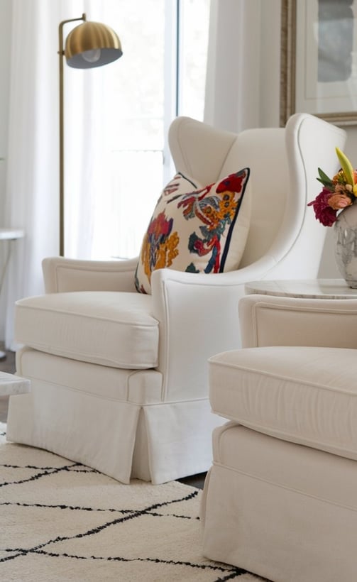 A furnished living room with a white chairs