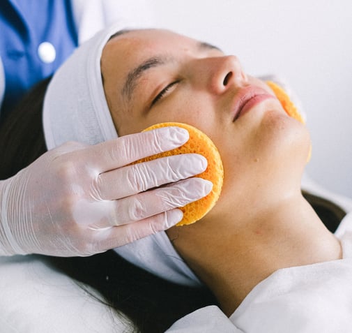 a woman with a towel on her face and a towel on her head