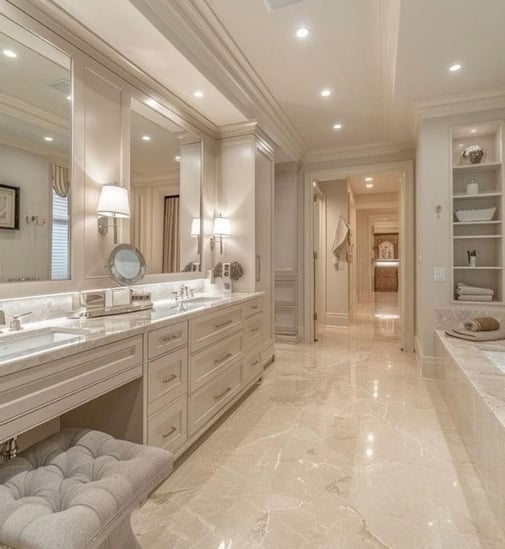 A luxurious bathroom with marble flooring, elegant lighting, and a spacious vanity.