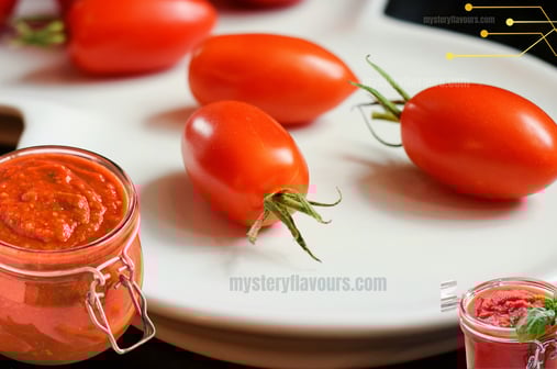 Freshly made delicious and simple homemade tomato sauce, in a jar, with fresh tomatoes