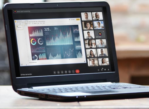 a laptop computer sitting on a table with a cup of coffee