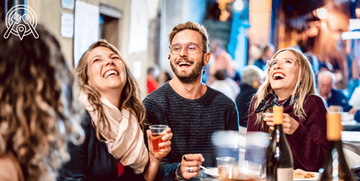 a group of people sitting at a table with drinks