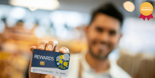 a man holding a reward card