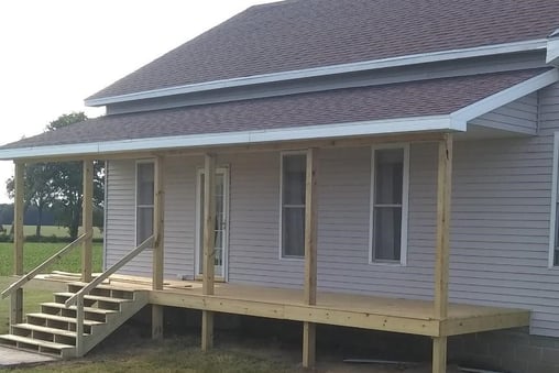 A new porch was added to this house in Goshen, IN. New shingles were fastened on the roof, as well.