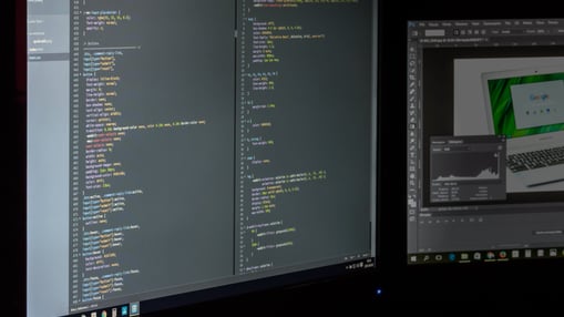 a computer monitor screen showing a computer screen with a computer monitor and a laptop