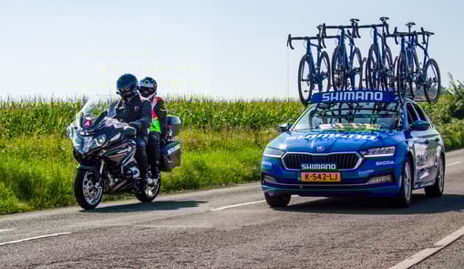 Tour of Britain Wrexham stage two, Commissaire bike overtaking Shimano tour car.