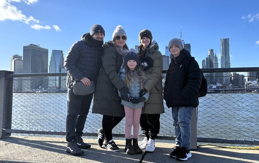 A family portrait of Ben, Claire, Lilie, Drew & Poppy Walker against the backdrop of New York taken in Brooklyn