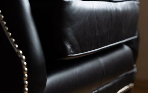 black leather armchair with decorative nails