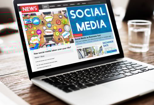 a laptop computer screen with a news pager on the screen