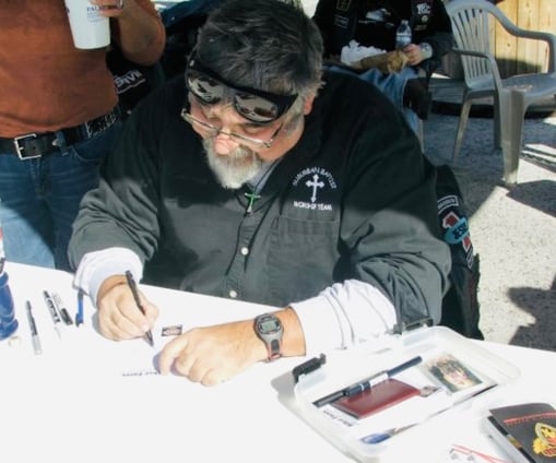 Caricature artist drawing biker cartoons.