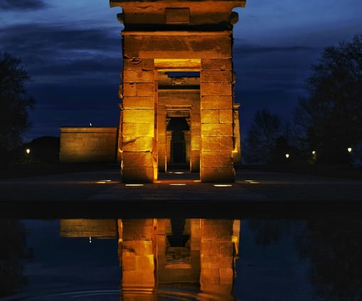 debot temple is a large stone structure with a dark sky in the background