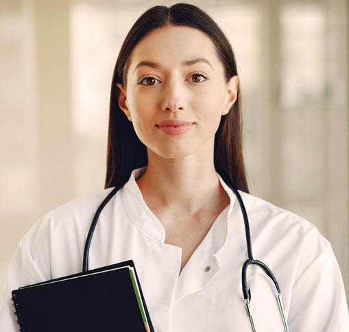 Female doctor with long brown hair wearing lab coat and stethoscope and holding a black notebook