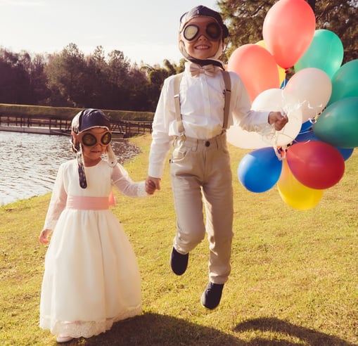a man and a little girl are holding balloons