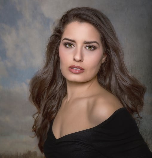 a woman in a black dress posing for a portrait