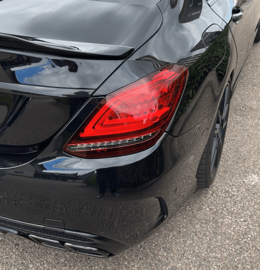 a black car parked in a parking lot