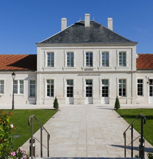mairie champniers a large white building with a long walkway