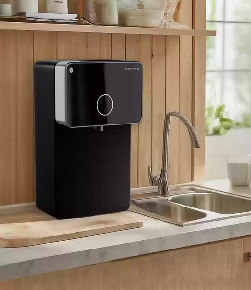 a black and white kitchen with a water purifier