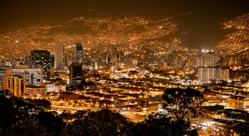 a cityscape of a city at night in Medellín, Colombia