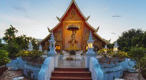 a small shrine with a statue of a woman in Chiang Mai, Thailand