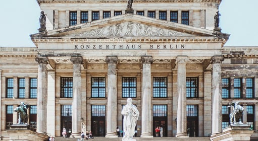 a building with a statue of a man on the steps in Berlin, Germany