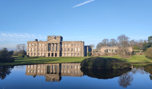 Grand mansion reflected in still water