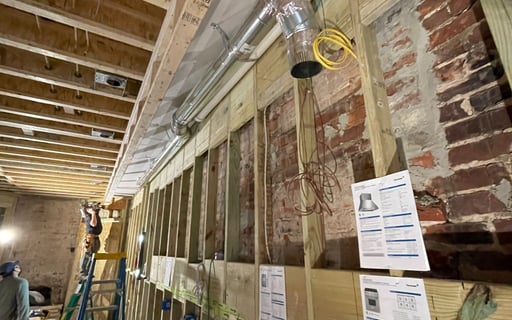 a man standing in a room with a ladder and a ladder