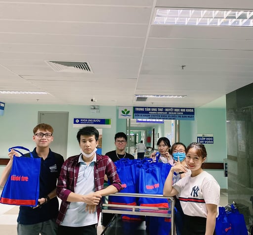 a group of people standing around a carton