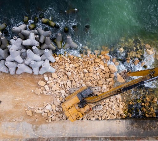 miami seawall waterfront with water and an excavator