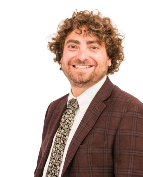 Ari Malman, Denver Attorney; a man in a suit and tie smiling