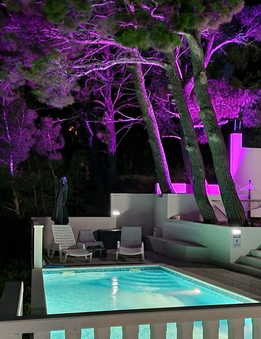 The photo shows the illuminated pool and part of the courtyard with ambient light.