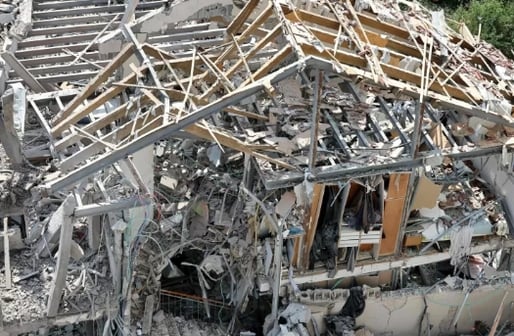 a building with a roof that has been destroyed by a crane