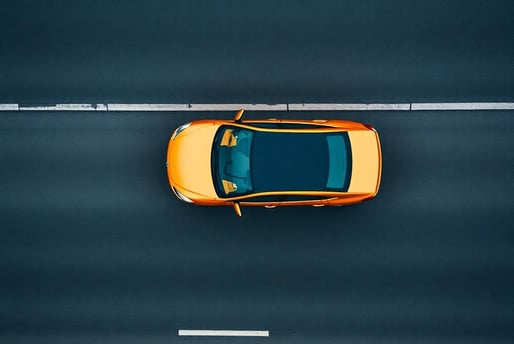 um carro dirigindo em uma rodovia com um carro amarelo